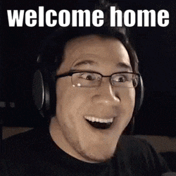 a man wearing headphones and glasses is making a funny face and saying welcome home .