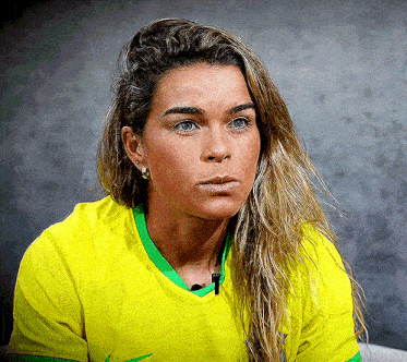 a woman is wearing a yellow shirt with green trim