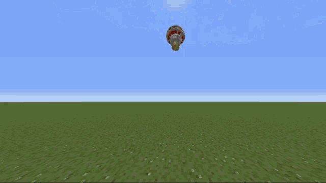 a hot air balloon is flying over a field of grass