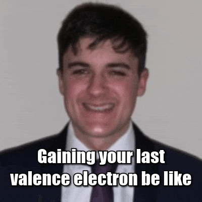 a man in a suit and tie is smiling with a caption that says gaining your last valence electron be like