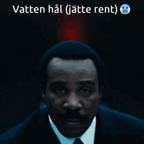a man in a suit and tie with the words vatten hal ( jätte rent ) below him