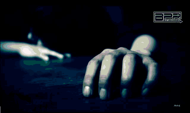 a blurry picture of a person 's hands on a table with the letters bpr on the top
