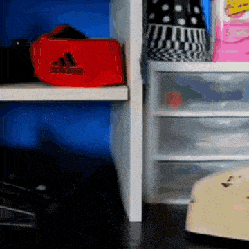 a red adidas hat sits on a shelf