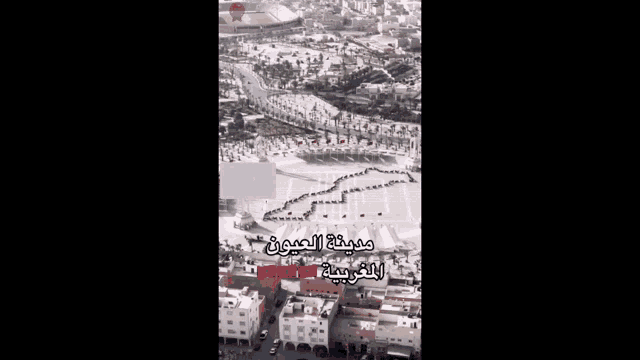 an aerial view of a snowy city with arabic writing on the bottom