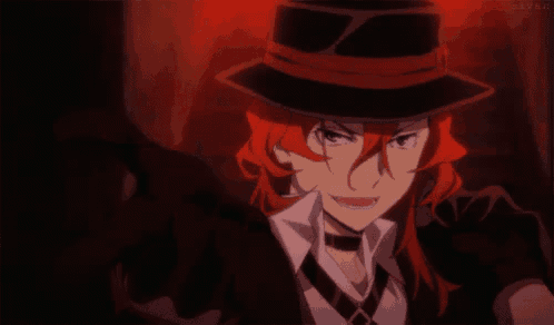 a man with red hair wearing a hat and tie