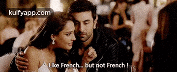a man and a woman are sitting next to each other in a restaurant and the woman says like french but not french