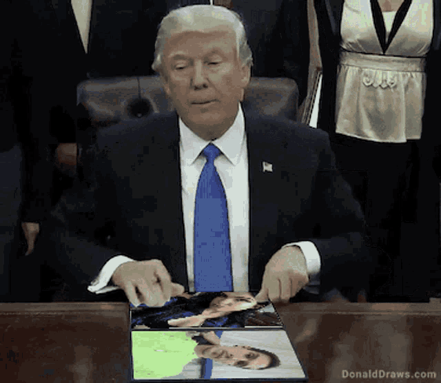a man in a suit and tie is sitting at a table with donalddraws.com written on it