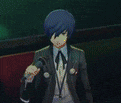 a man in a suit is singing into a microphone in a dark room .