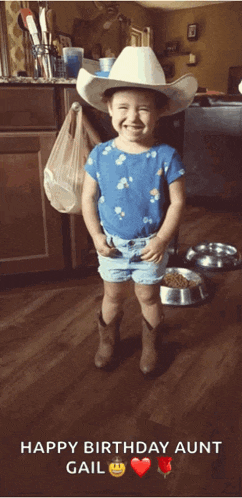 a little girl wearing a cowboy hat and shorts is standing in a kitchen