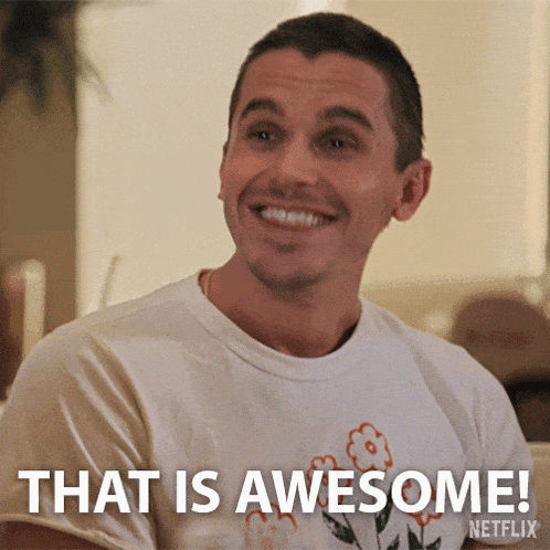 a man wearing a t-shirt that says " that is awesome " is smiling