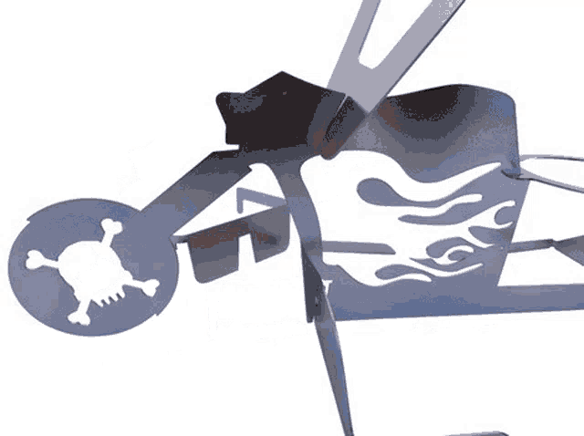a silhouette of a skull and crossbones on a metal object