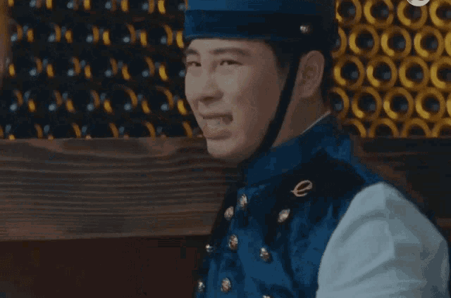 a man wearing a blue uniform with a gold e on the chest