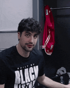 a man is wearing a black shirt that says black hustle