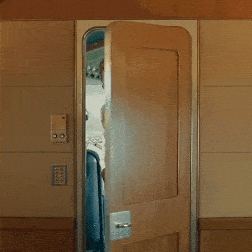 a man standing in a doorway with the words " is this supposed to be here "