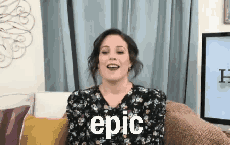 a woman is sitting on a couch with the word epic written on her face