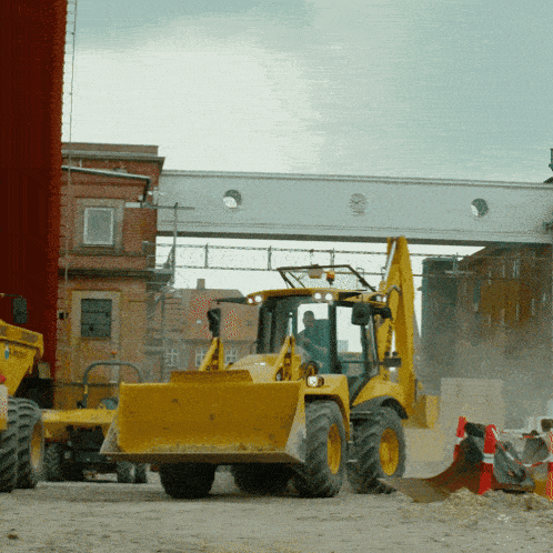 a yellow tractor with a bucket that says jcb on it
