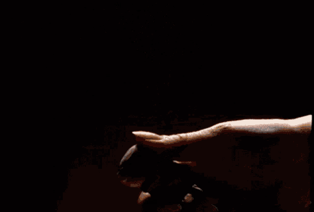 a close up of a person spraying a bottle of perfume