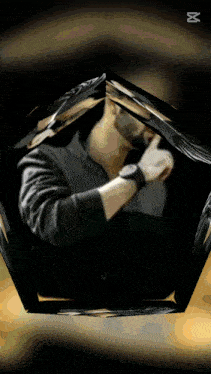 a man with a watch on his wrist is surrounded by a geometric shape