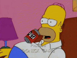 homer simpson is sitting on a couch drinking a can of duff beer