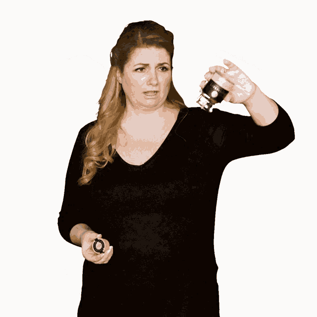 a woman in a black shirt is holding a bottle that says ' a' on it