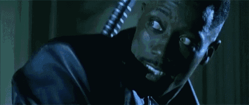 a close up of a man 's face in a dark room .