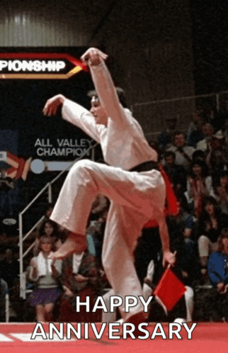 a man in a karate uniform is jumping in the air with the words happy anniversary written below him
