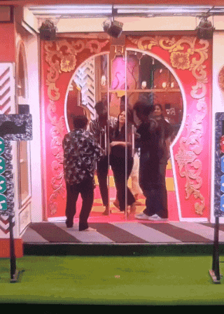 a group of people standing in front of a door with a keyhole design