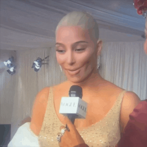 a woman is talking into a microphone that says vogue