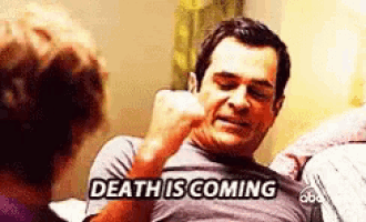 a man is sitting on a couch talking to a woman and saying `` death is coming ''