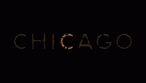 a sign that says chicago is lit up in the dark