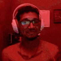 a man wearing headphones and glasses is taking a selfie