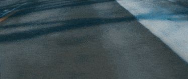a black car is driving down a road with a license plate that says ' aa ' on it