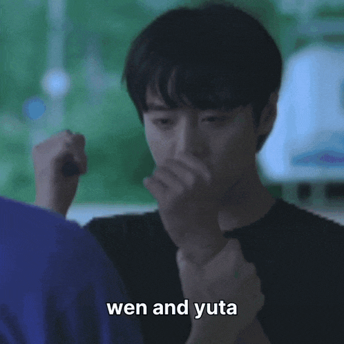 a man in a purple shirt is pointing at another man with the caption wen and yuta
