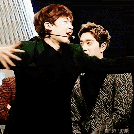 a gif of two men hugging with the words gif by fiuki on the bottom right