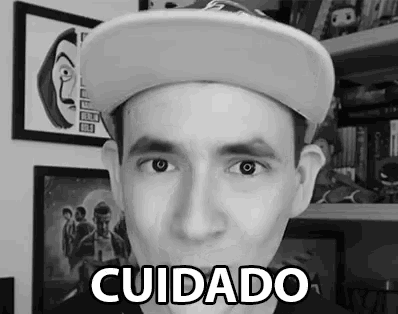 a black and white photo of a man wearing a hat with the word cuidado on it