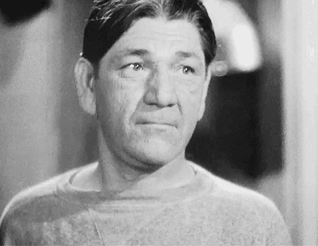 a black and white photo of a man in a sweater