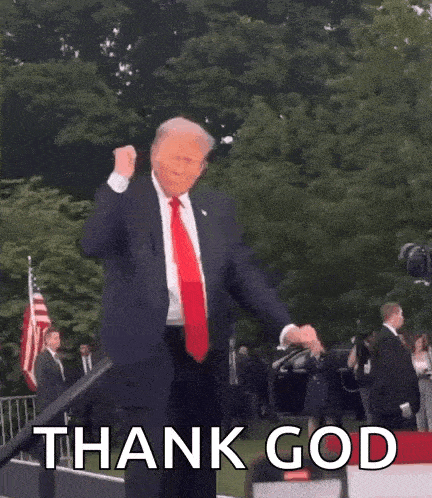 a man in a suit and tie is giving a thumbs up and the words thank god are visible