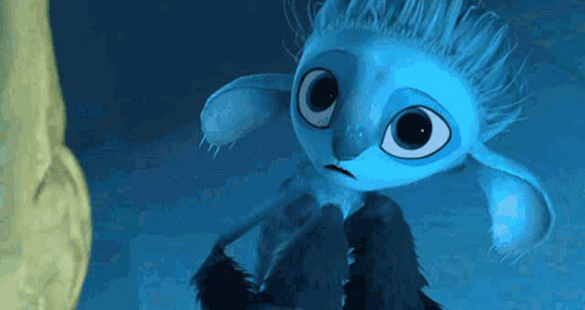 a close up of a blue cartoon character looking at the camera with a sad look on his face