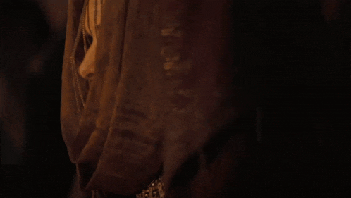 a close up of a woman 's face with a scarf around her neck