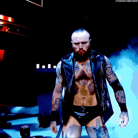 aleister black is a wrestler with a beard and tattoos on his body