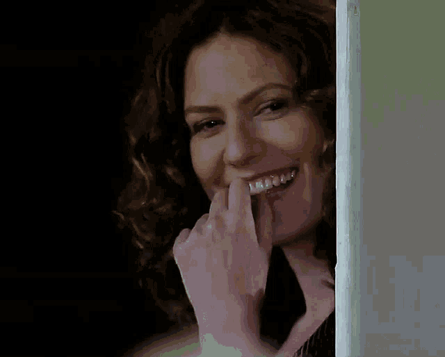 a woman with braces on her teeth is laughing