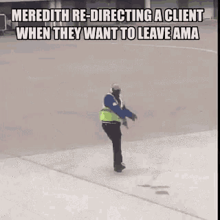 a man in a yellow vest is directing a client when they want to leave ama .