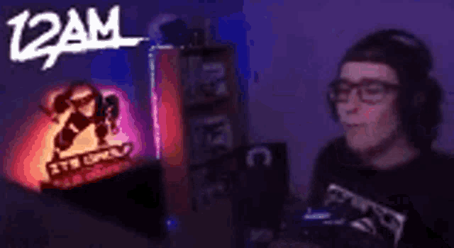a man wearing headphones is standing in front of a sign that says 12 am .