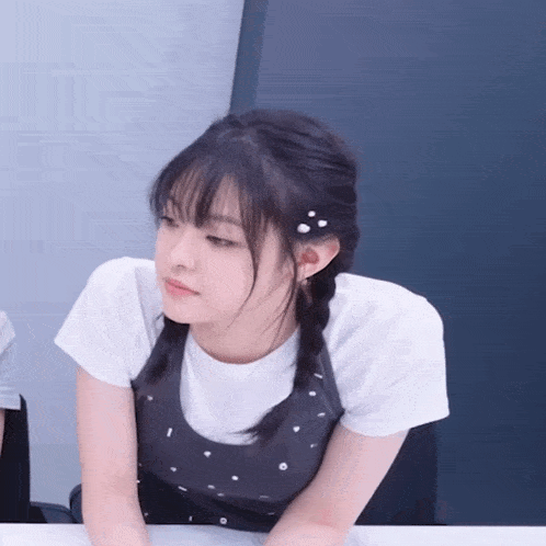 a girl with braids in her hair is wearing a white t-shirt