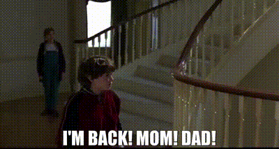 a boy and a girl are standing next to each other on a staircase and the girl is talking to the boy .