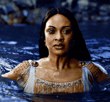 a woman in a dress is swimming in the water