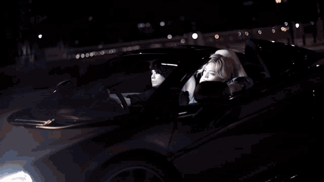 a car with the hood open is parked on the street