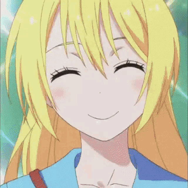 a close up of a girl 's face with a big smile