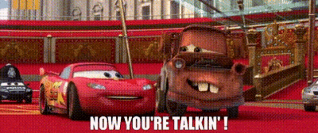 lightning mcqueen and mater from cars are standing next to each other on a red carpet and talking .