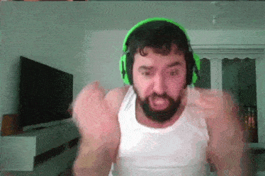 a man with a beard wearing green headphones and a white tank top .